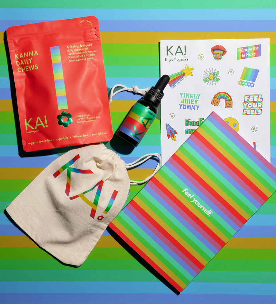 Assorted KA! products including a red pouch, bottle, and colorful items on a striped background